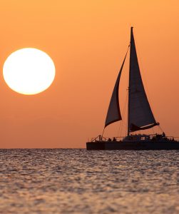 Red Sail Catamaran on sunset sail